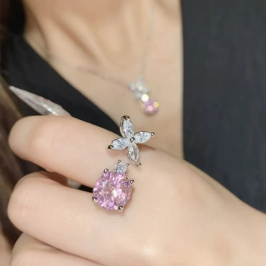 A Stylish And Exquisite Set Featuring a Pink Four-Leaf Flower, Round, Sweet And High-End Collarbone Chain, Ring, And Stud Earrings.